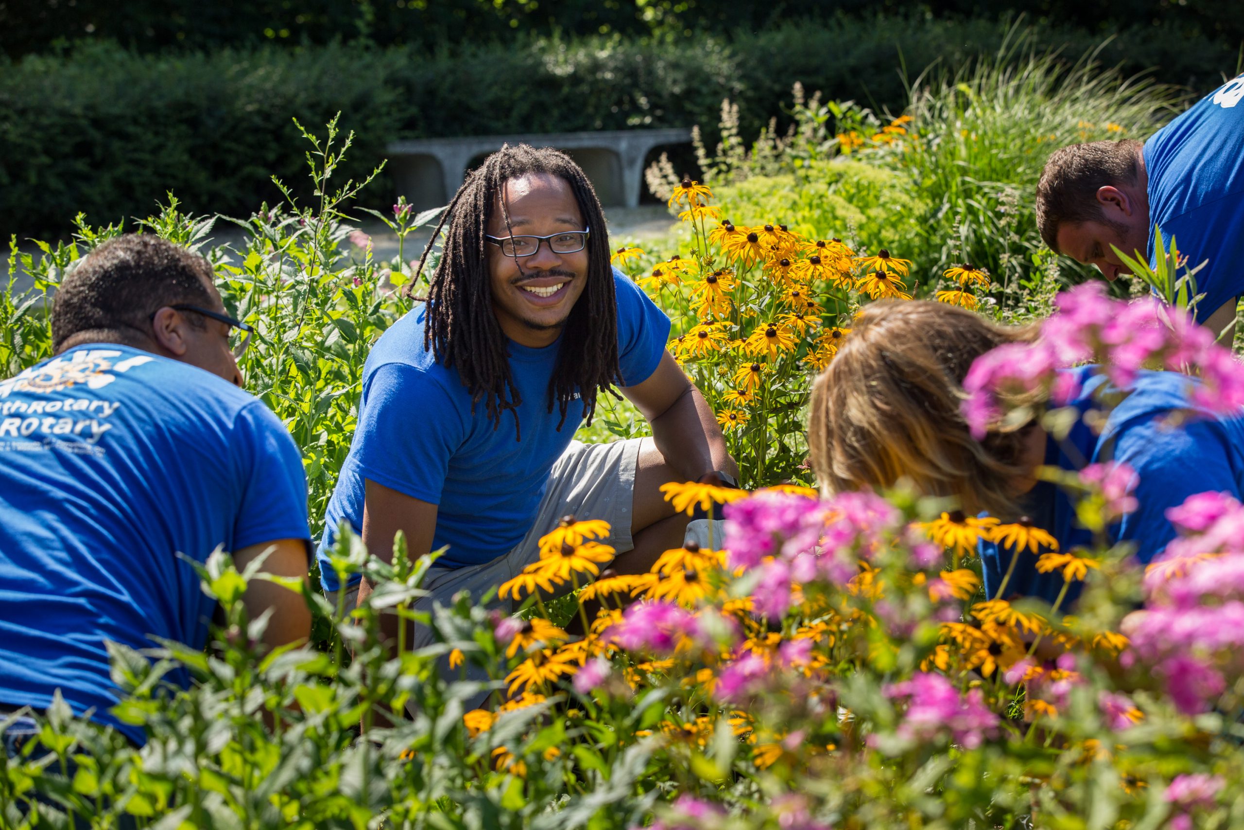 A group of students giving back in a garden. 